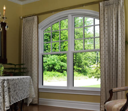 Ultra Series twin segment head Sterling double hung window with white hardware and PDL bars in the top sash.