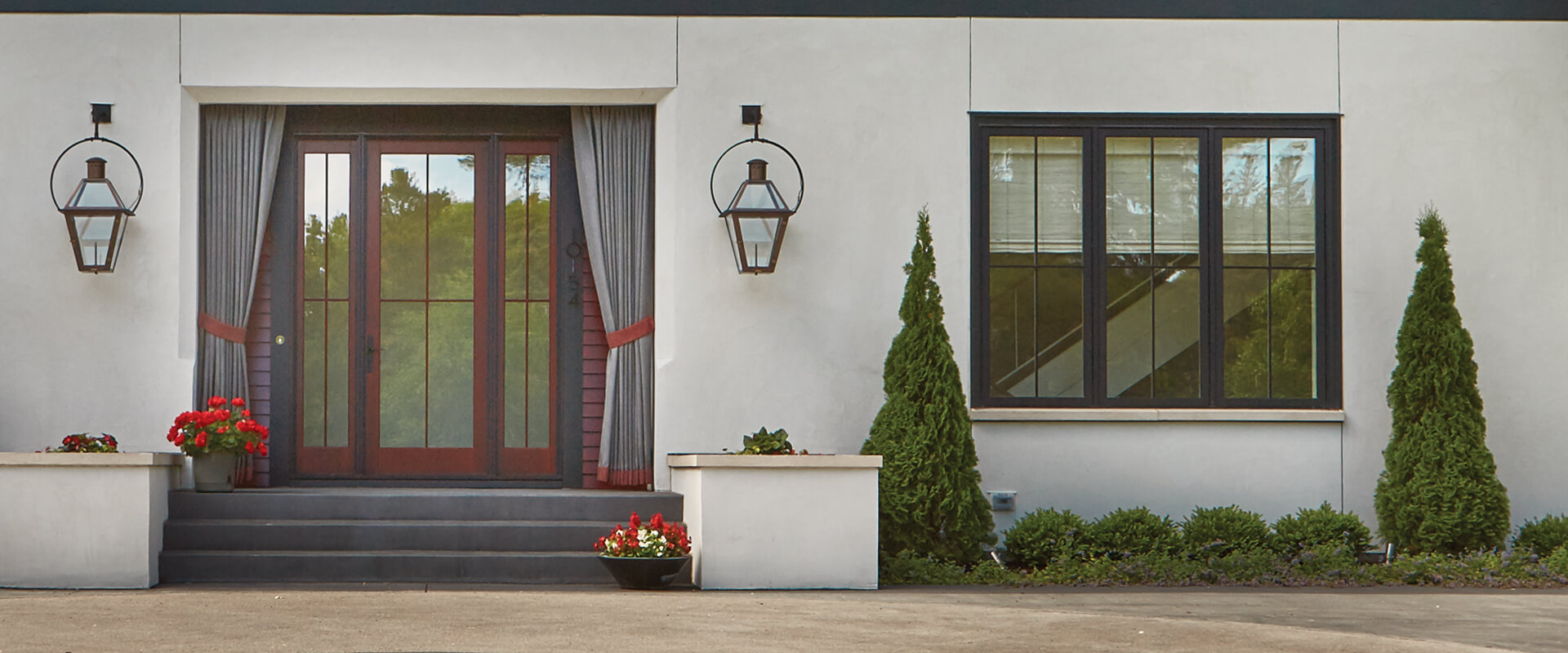 Heritage Series entrance doors with raised panels and an Ultra Series segment head transom.